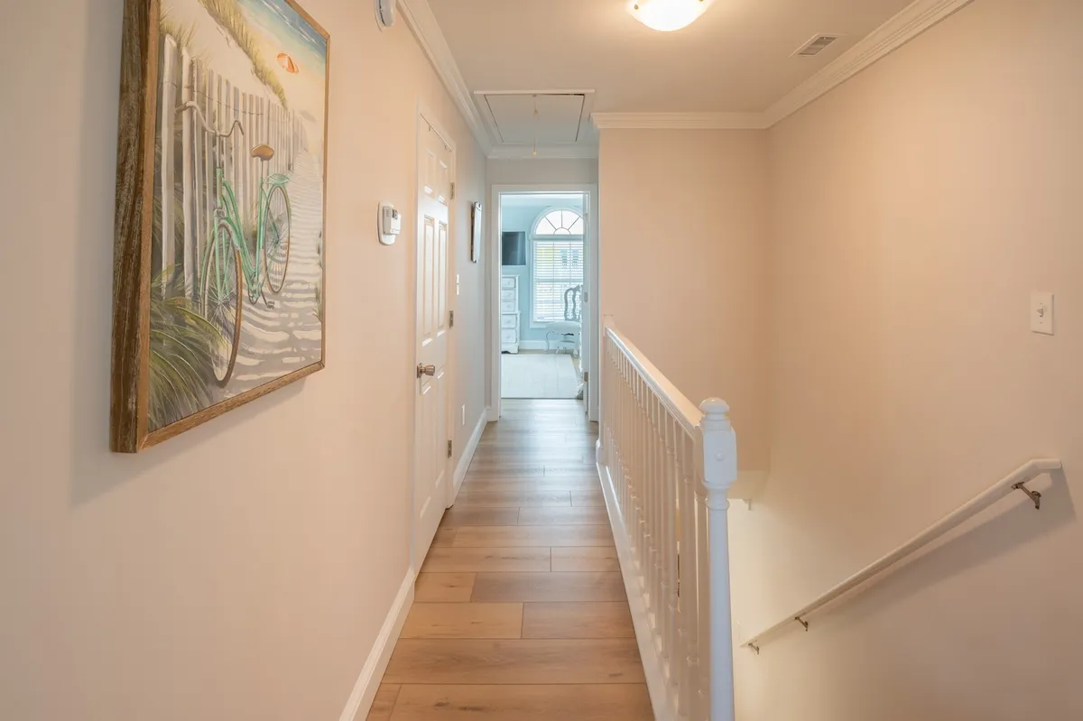 An inviting corner featuring painted bicycle artwork, a staircase, and a doorway leading further into the home. The scene hints at movement and exploration, with the bicycle art adding a playful, active touch.